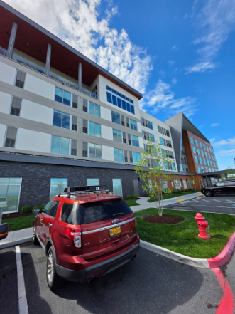 Commercial building exterior with unique red accent panels, clean windows